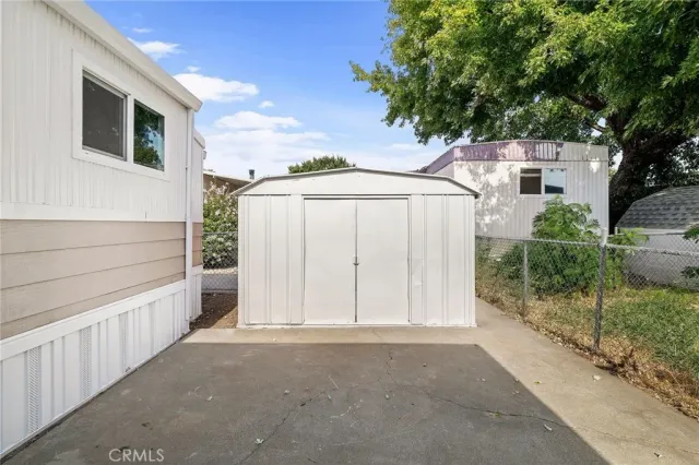 a view of kitchen with stainless steel appliances cabinets and outdoor space
