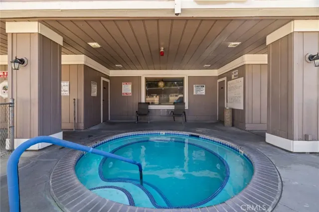 a room with lots of wooden furniture and a chandelier