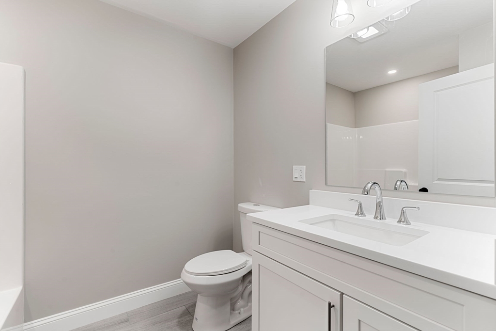 16 Bronson Street Fall River, MA 02721 - Photo 20 of 21 a bathroom with a sink a toilet and mirror