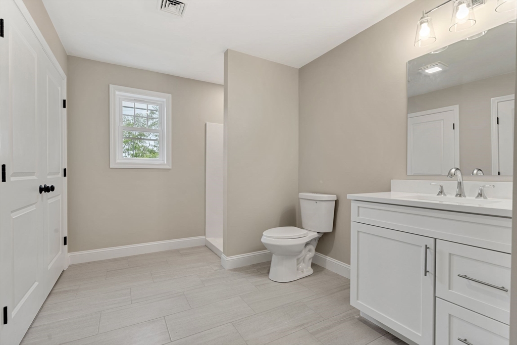 16 Bronson Street Fall River, MA 02721 - Photo 9 of 21 a bathroom with a toilet sink and mirror