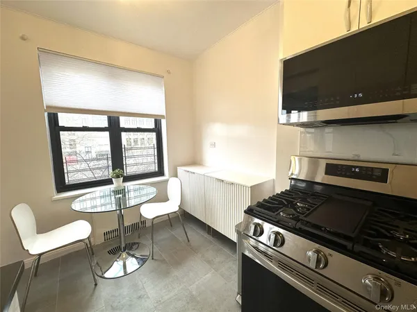 a kitchen with a stove and white cabinets