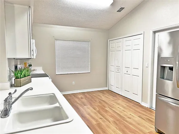 a view of a kitchen cabinets a sink and dishwasher wooden floor