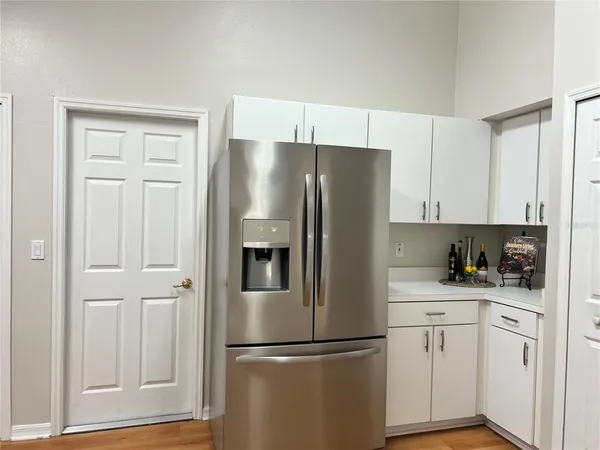 a kitchen with stainless steel appliances a refrigerator and cabinets