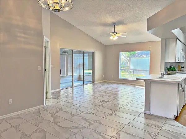 a view of an empty room with window and cabinet
