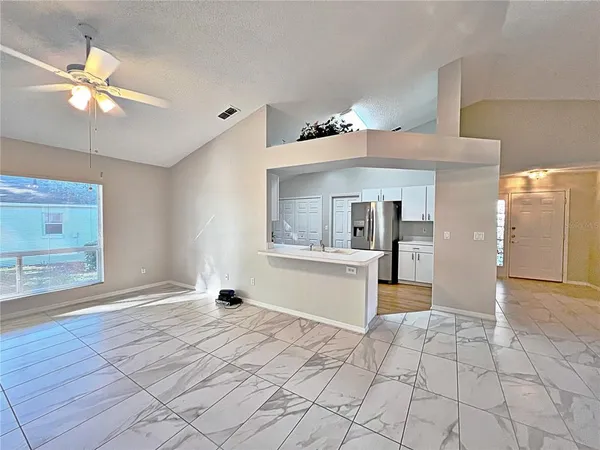 a view of an entryway with a chandelier fan and wooden floor