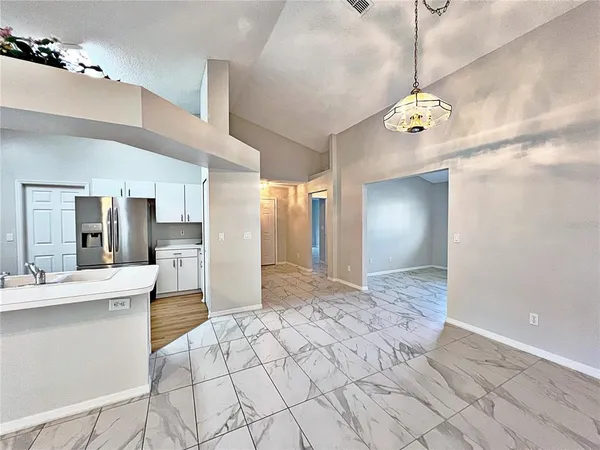 a view of a kitchen with a sink and chandelier
