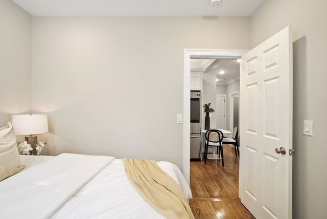 a bedroom with a bed and a table with painted walls