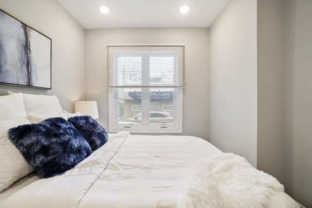 a bedroom with a large bed and a window