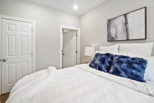 a bedroom with a large bed and a bathroom