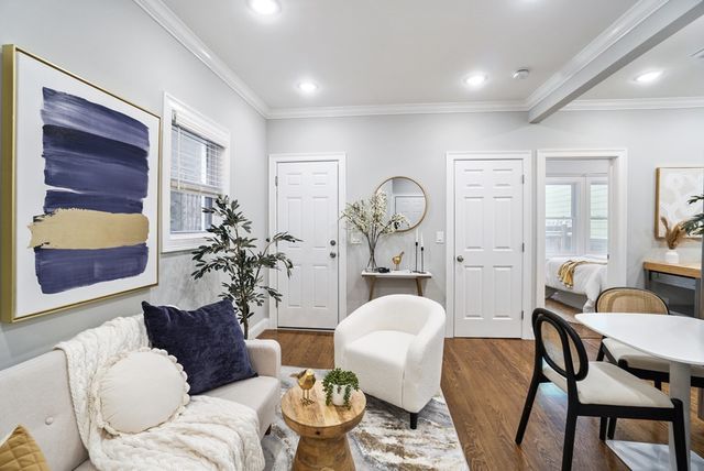 a living room with furniture and wooden floor