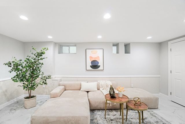 a living room with furniture and a potted plant