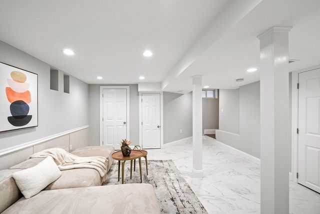 a living room with furniture and a large mirror