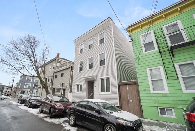 a car parked in front of a brick building