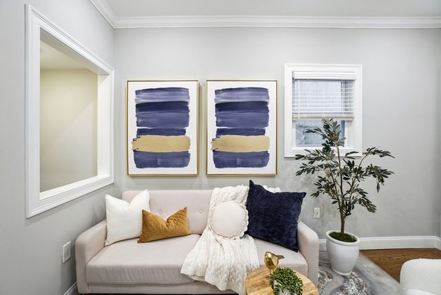 a living room with furniture and a potted plant