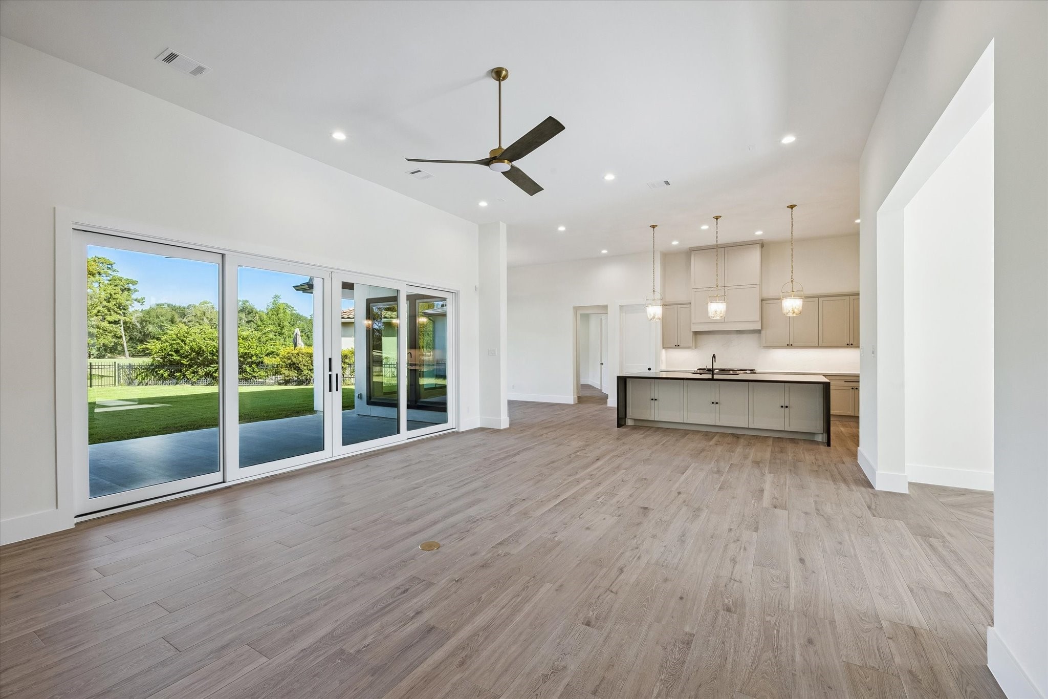 65 Shadow Creek Ridge Drive Spring, TX 77389 - Photo 11 of 41 Oversized sliding glass doors stretch across the back wall, inviting natural light and easy indoor-outdoor flow to the covered patio and backyard views.