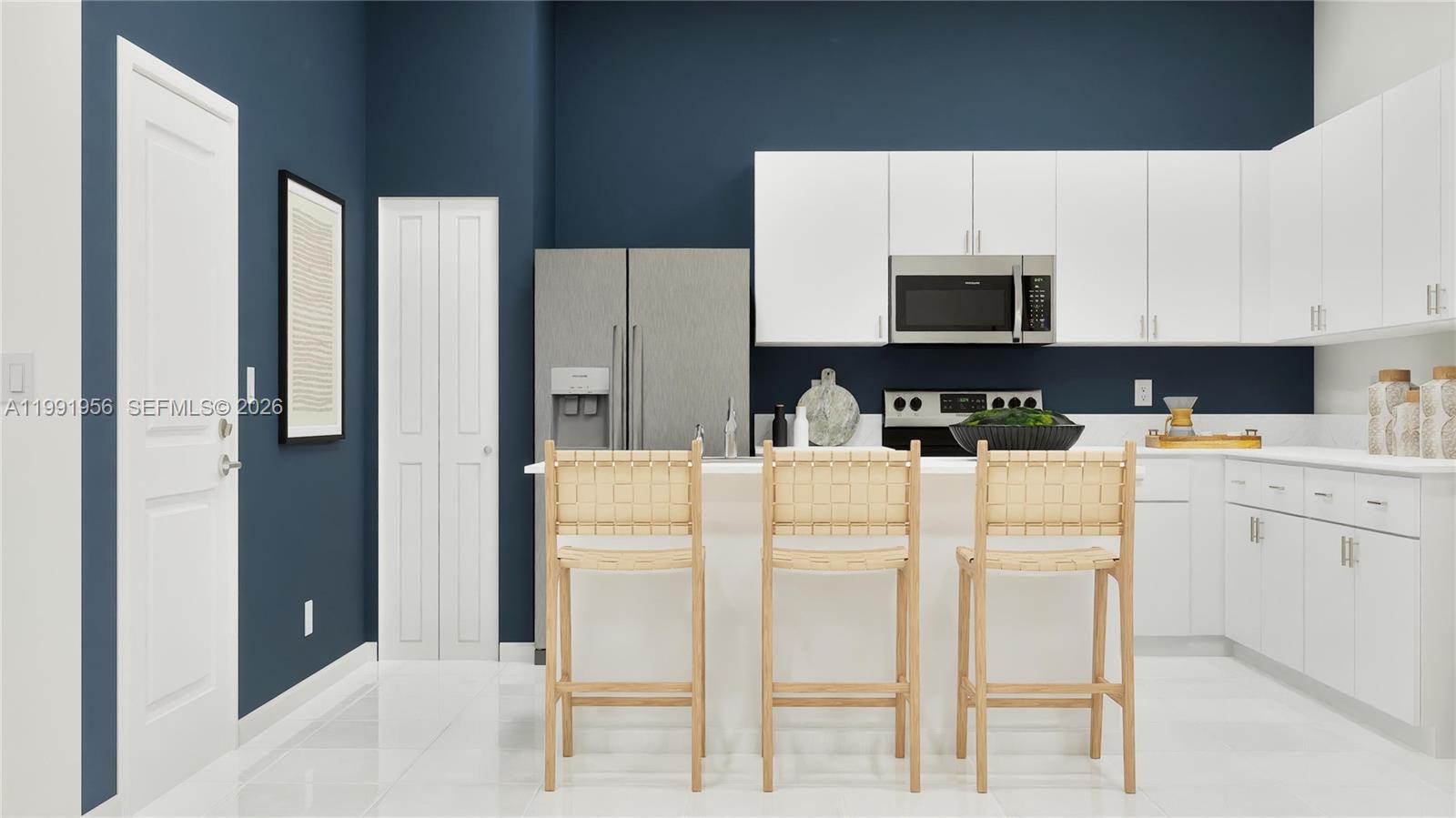 18877 Southwest 315th Street Homestead, FL 33030 - Photo 2 of 5 a kitchen with stainless steel appliances white cabinets and a refrigerator