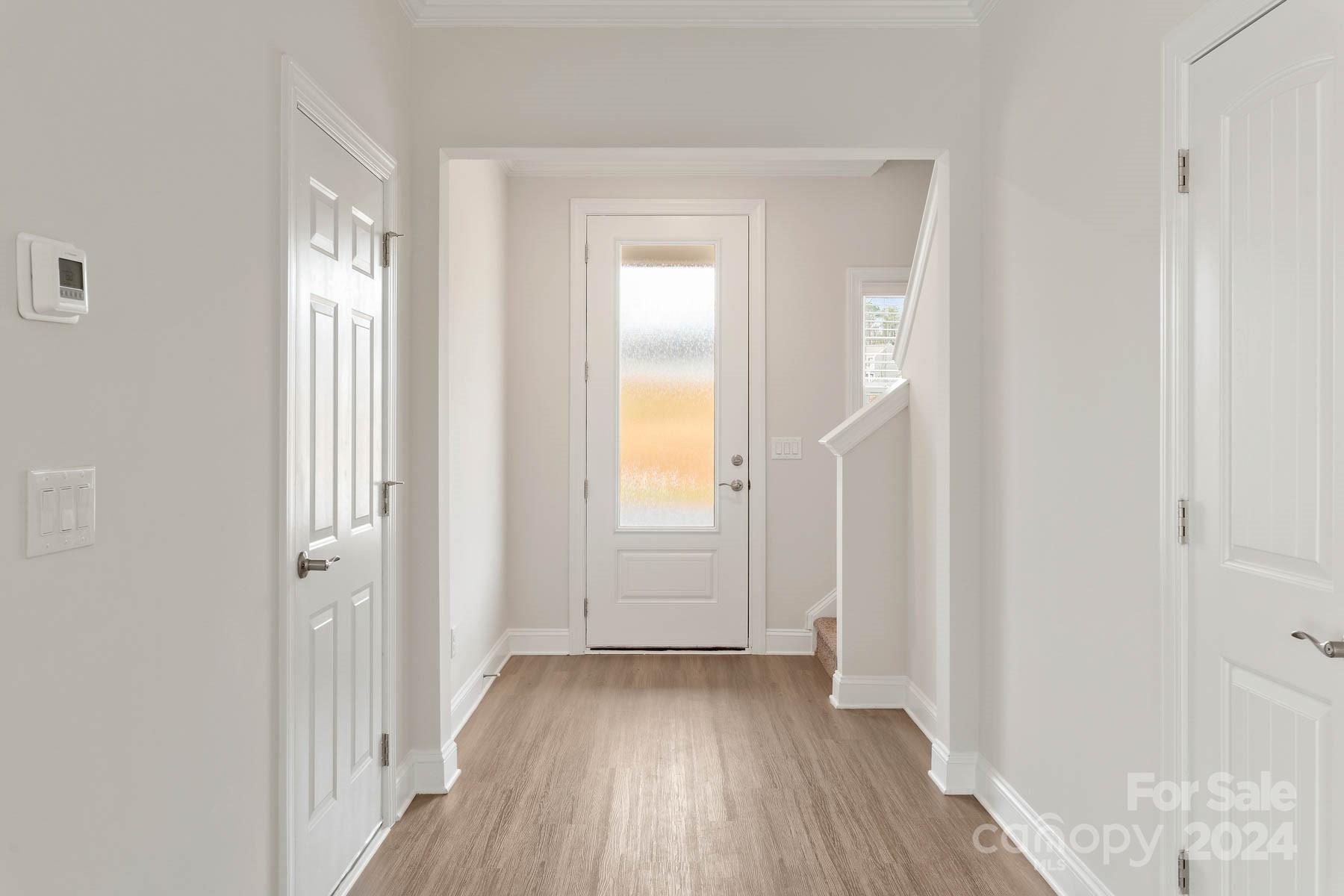 105 Brixham Loop Troutman, NC 28166 - Photo 2 of 13 a view of a hallway with wooden floor and closet