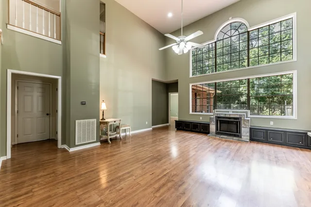 a view of a livingroom with furniture window wooden floor and windows