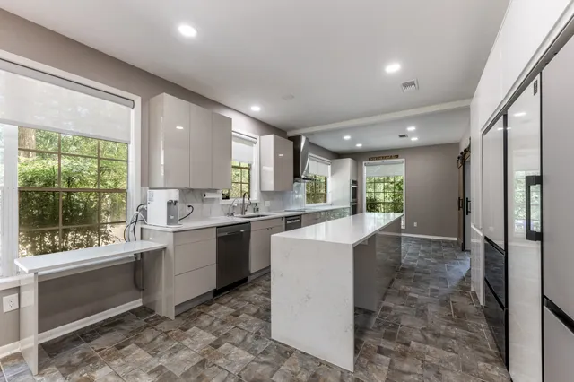 a kitchen with sink cabinets and refrigerator