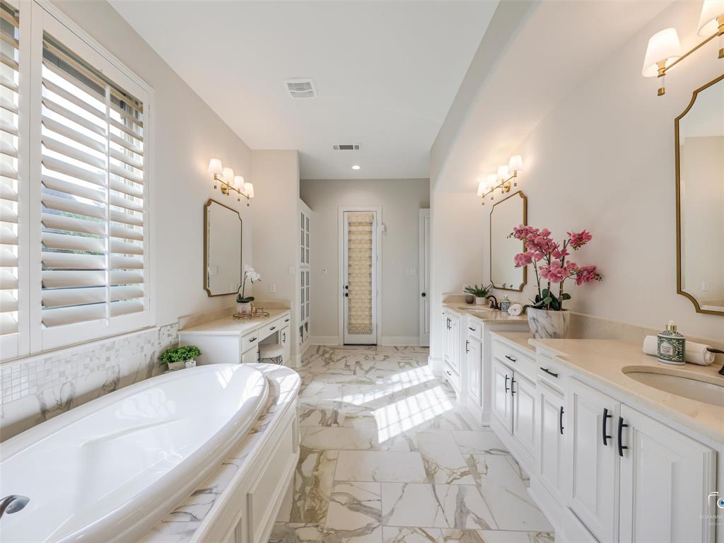 3117 Callander The Colony, TX 75056 - Photo 24 of 40 Primary bathroom with Primary bathroom has built-in linen closet, dual sink vanity, make up vanity, soaker tub and separate shower.