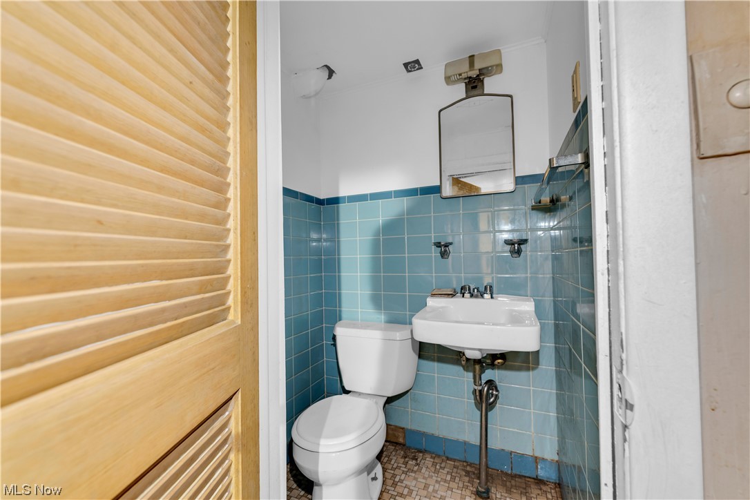 5619 Dunham Road Maple Heights, OH 44137 - Photo 18 of 19 Bathroom with tile walls, toilet, tile flooring, and washbasin
