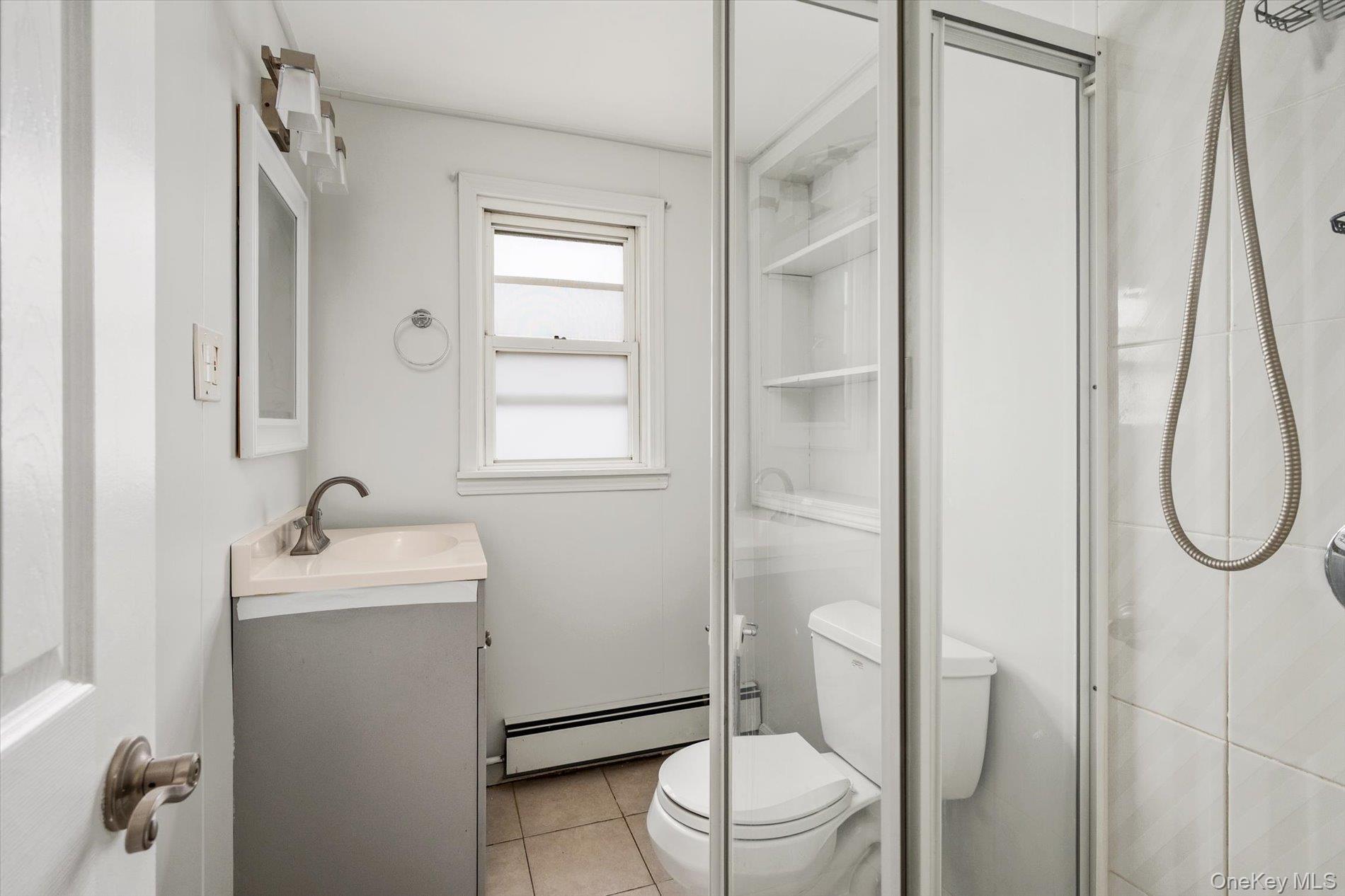20 Kenneth Avenue Bellmore, NY 11710 - Photo 11 of 24 a bathroom with a sink toilet and shower