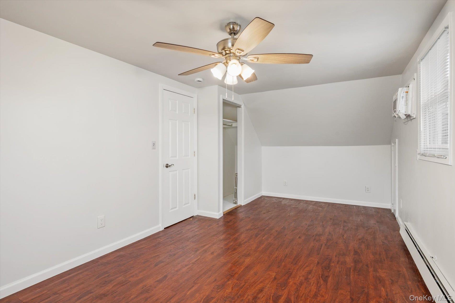 20 Kenneth Avenue Bellmore, NY 11710 - Photo 13 of 24 an empty room with wooden floor fan and windows