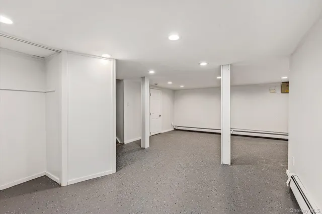 a view of an empty room with a refrigerator