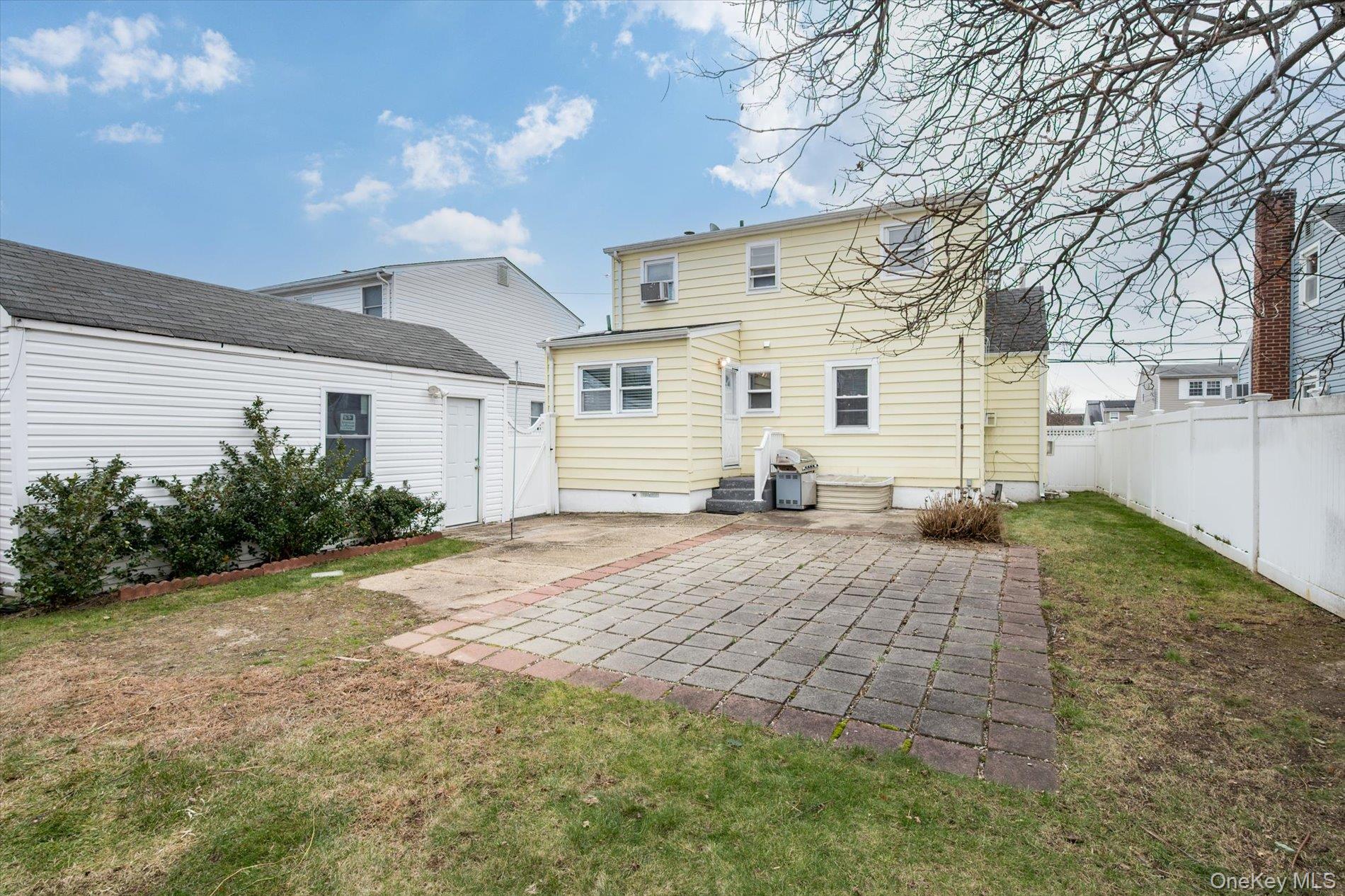 20 Kenneth Avenue Bellmore, NY 11710 - Photo 20 of 24 a view of a white house with a yard