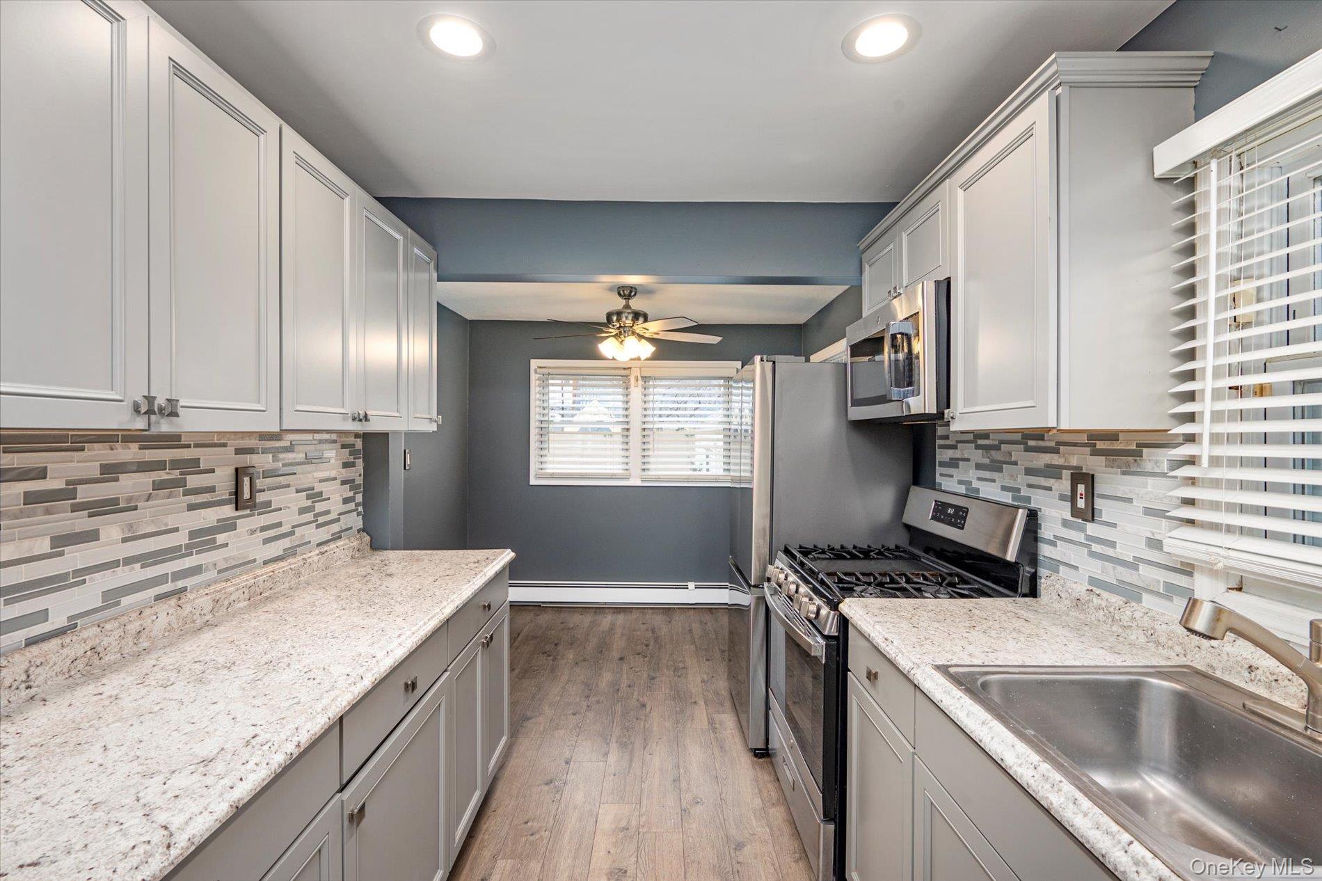 20 Kenneth Avenue Bellmore, NY 11710 - Photo 4 of 24 a kitchen that has a sink and a stove