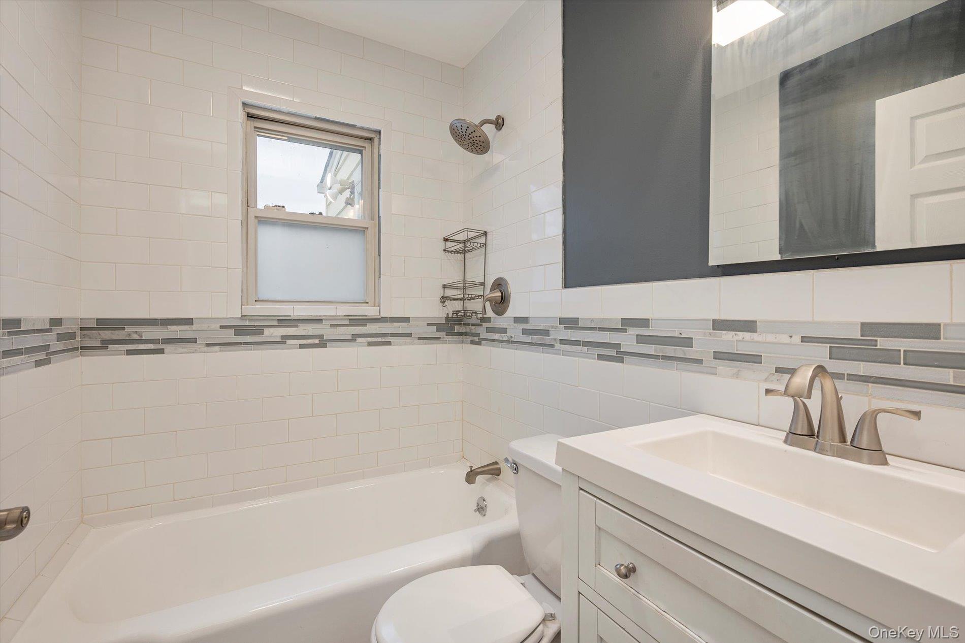 20 Kenneth Avenue Bellmore, NY 11710 - Photo 8 of 24 a bathroom with a sink and a mirror