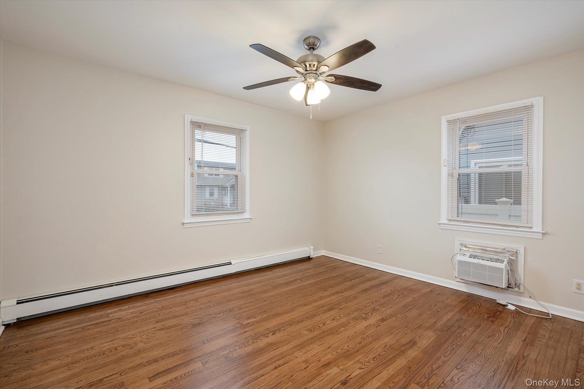 20 Kenneth Avenue Bellmore, NY 11710 - Photo 9 of 24 a view of a big room with wooden floor and windows