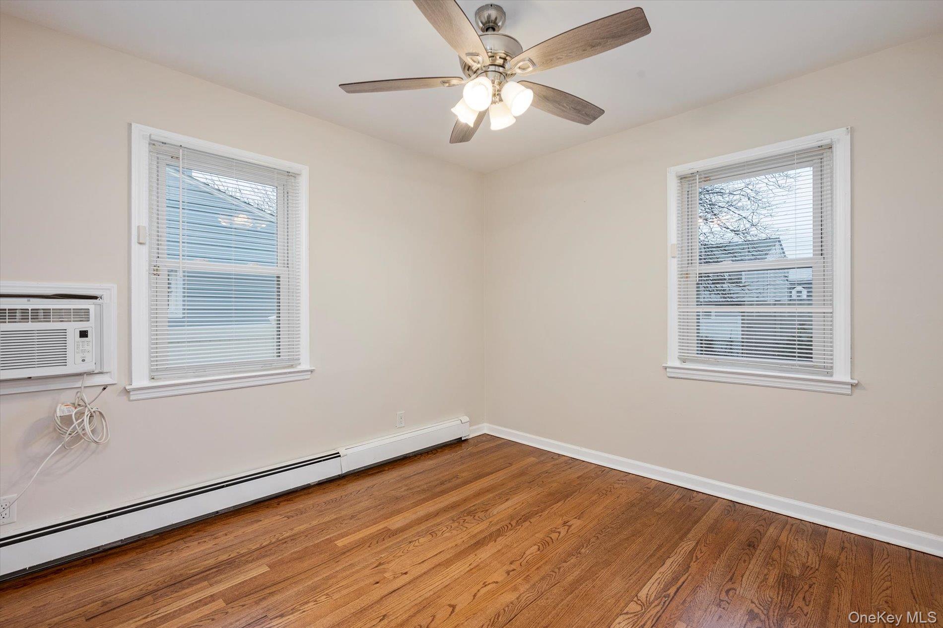 20 Kenneth Avenue Bellmore, NY 11710 - Photo 10 of 24 a view of empty room with wooden floor and fan