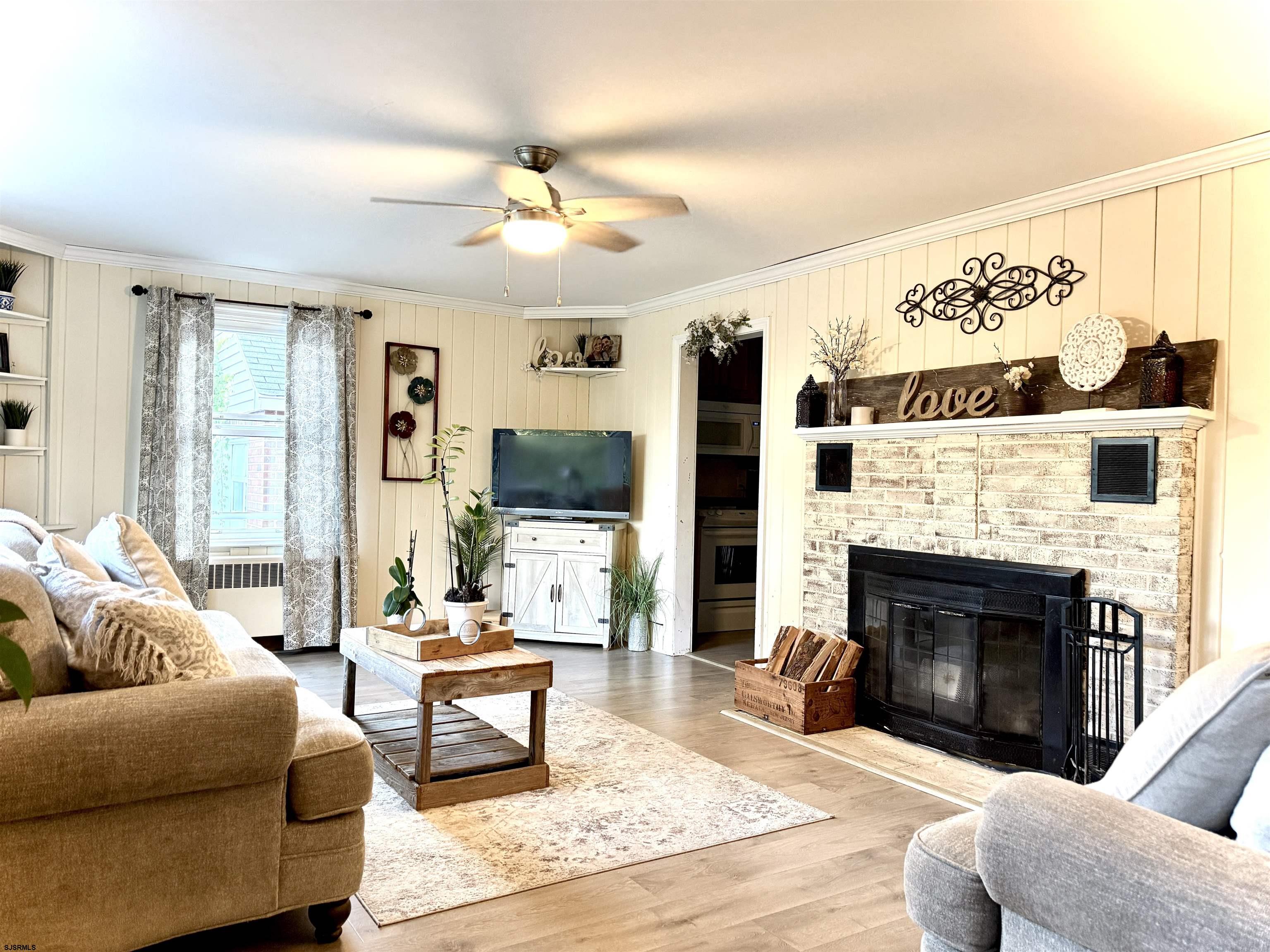 605 Shore Road Linwood, NJ 08221 - Photo 10 of 99 a living room with furniture a fireplace and a flat screen tv