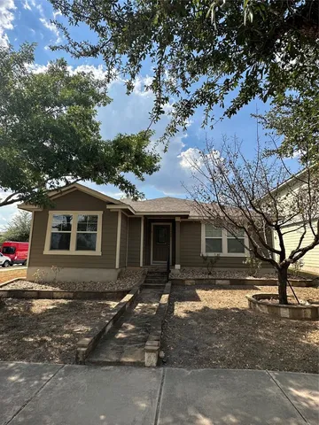 a front view of a house with yard