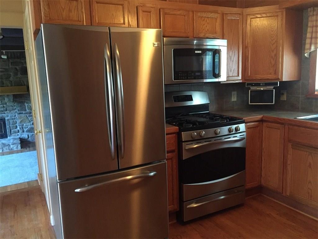 685 Pluto Road Ligonier, PA 15658 - Photo 9 of 25 Hardwood floors, oak cabinets, and stairs to the great room...