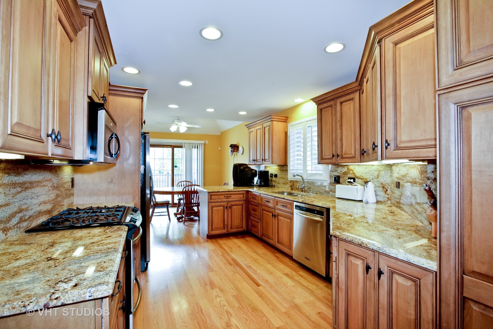 231 South Lincoln Street Westmont, IL 60559 - Photo 3 of 9 a kitchen with stainless steel appliances granite countertop sink stove top oven and cabinets