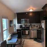 a kitchen with refrigerator and chairs