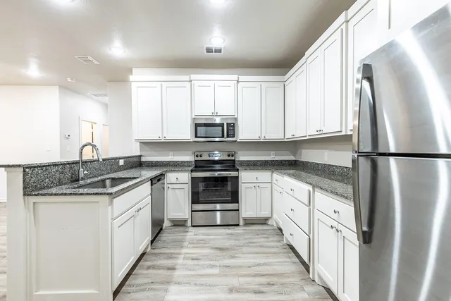 a kitchen with a sink and cabinets