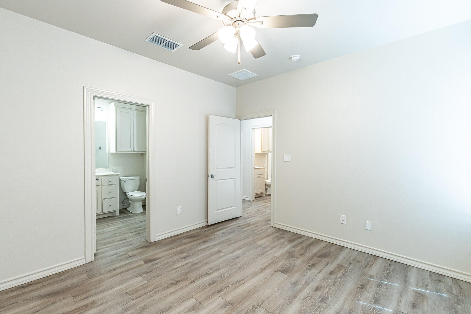 5502 Kemper Street Lubbock, TX 79416 - Photo 8 of 17 an empty room with wooden floor and ceiling fan