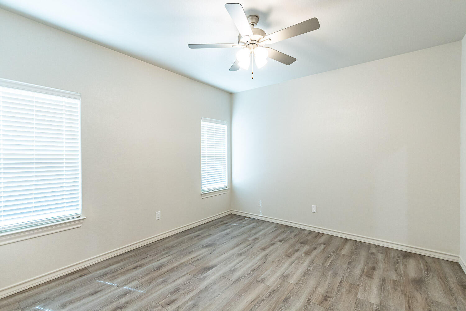 5502 Kemper Street Lubbock, TX 79416 - Photo 10 of 17 an empty room with a window and a fan
