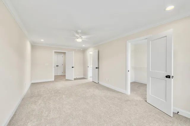 an empty room with a ceiling fan and a window
