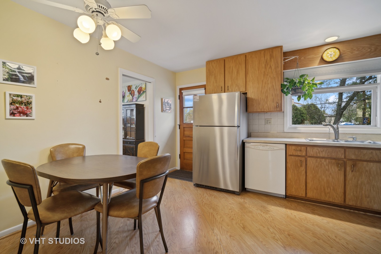207 Michael Manor Glenview, IL 60025 - Photo 3 of 20 a kitchen with stainless steel appliances granite countertop a dining table chairs refrigerator and sink