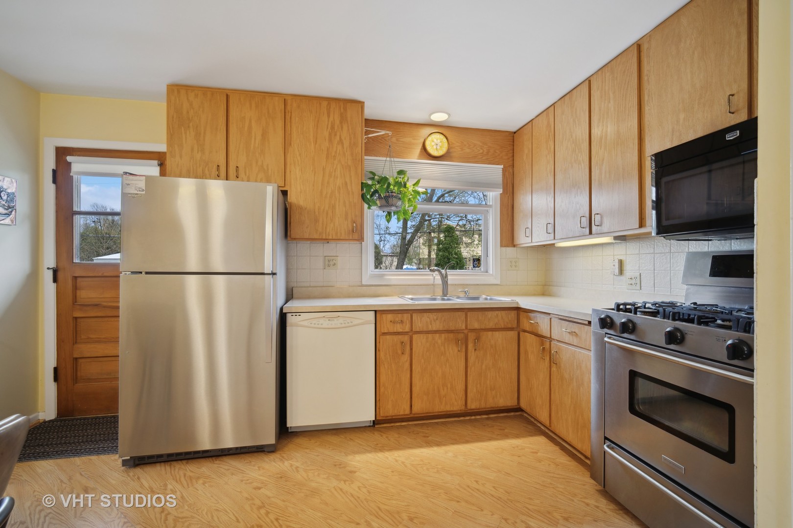 207 Michael Manor Glenview, IL 60025 - Photo 4 of 20 a kitchen with stainless steel appliances granite countertop a refrigerator stove a sink dishwasher and microwave