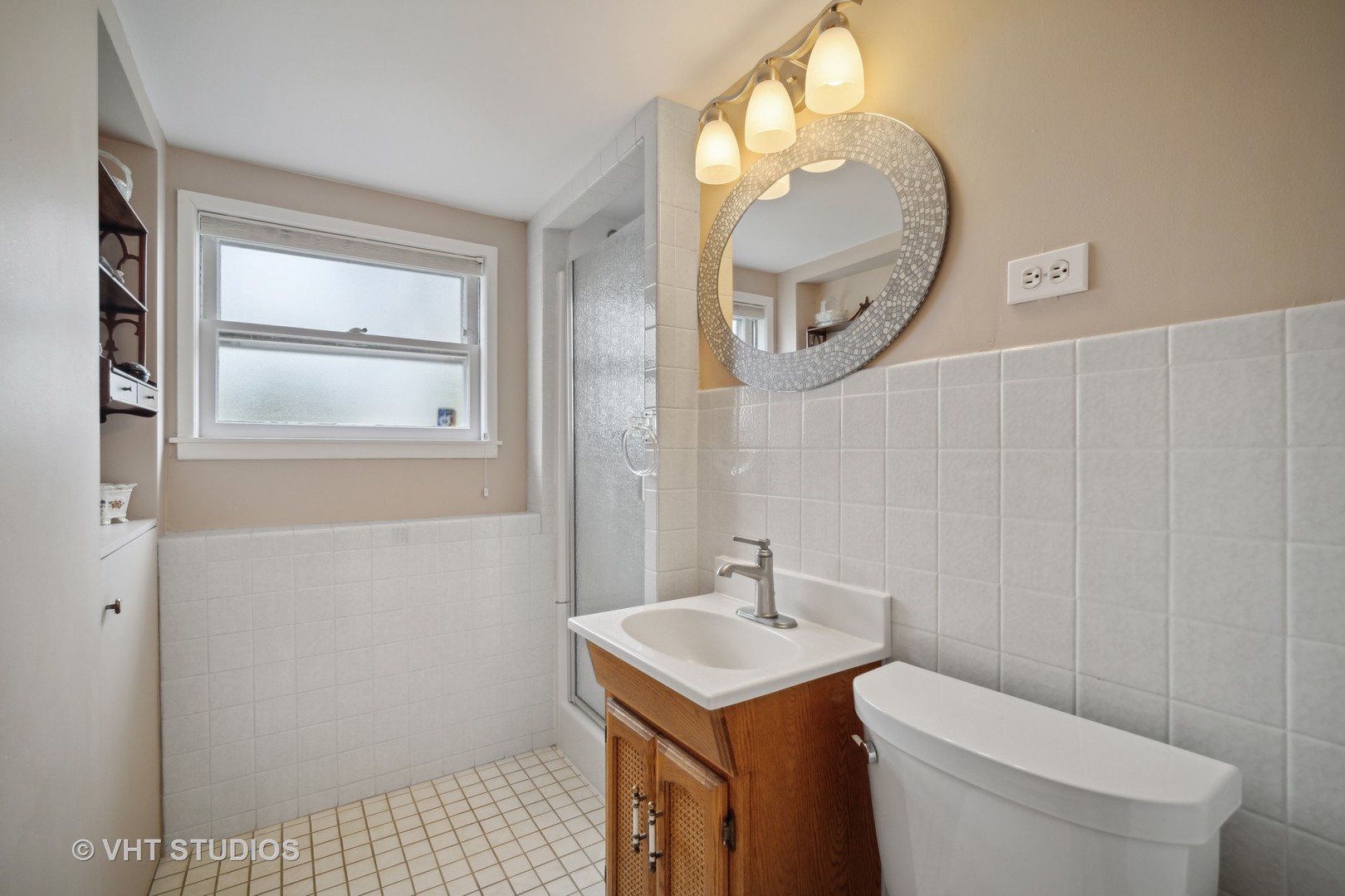 207 Michael Manor Glenview, IL 60025 - Photo 7 of 20 a bathroom with a sink a mirror a toilet and a window