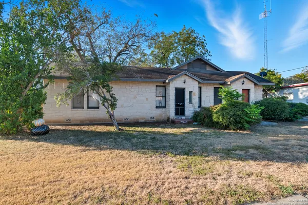 a house that has a tree in front of it