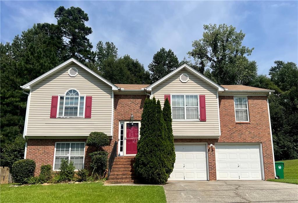 6035 Valley Green Road Lithonia, GA 30058 - Photo 1 of 1 a front view of a house with a yard and garage