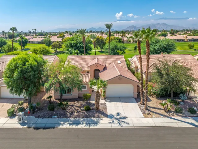 a aerial view of a house with garden space and street view