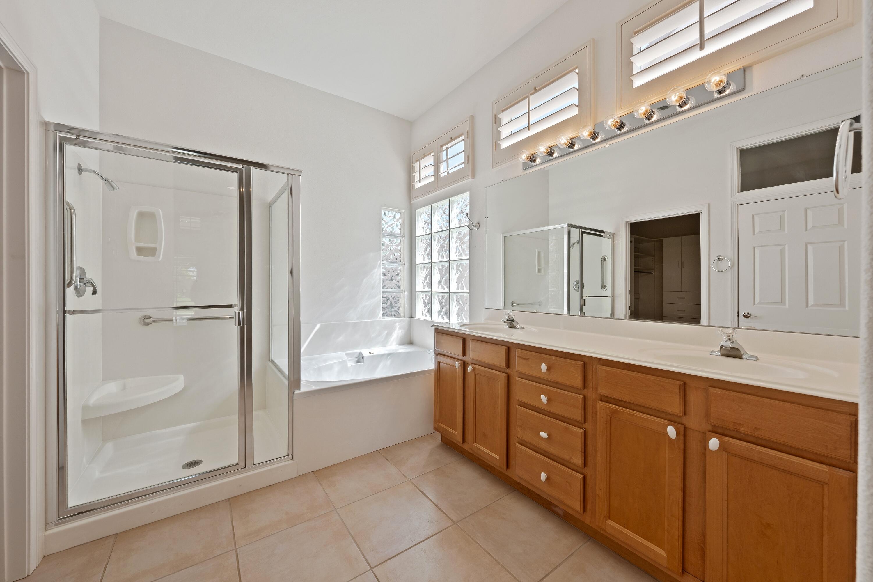 78513 Sunrise Mountain View Palm Desert, CA 92211 - Photo 30 of 45 a spacious bathroom with a granite countertop sink mirror and bathtub