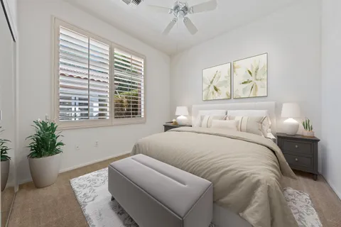 a bathroom with a granite countertop toilet a sink a mirror and a window